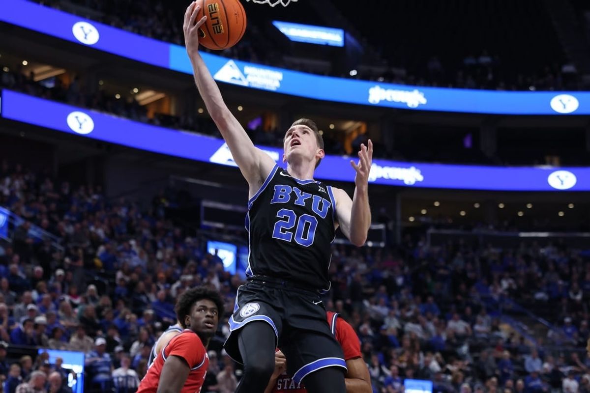 Dec 1, 2023; Salt Lake City, Utah, USA; Brigham Young Cougars guard Spencer Johnson (20) lays the ball up against the Fresno State Bulldogs during the first half at Delta Center.