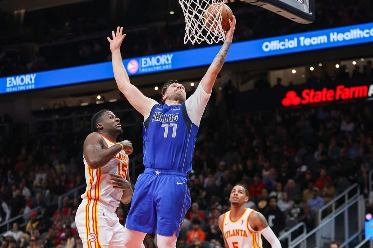 Jan 26, 2024; Atlanta, Georgia, USA; Dallas Mavericks guard Luka Doncic (77) shoots against the Atlanta Hawks in the second quarter at State Farm Arena.