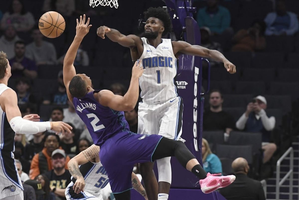 Mar 5, 2024; Charlotte, North Carolina, USA;  Orlando Magic forward Jonathan Isaac (1) defends against Charlotte Hornets forward Grant Williams (2) during the first half at the Spectrum Center.