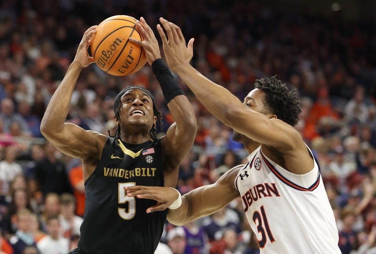 Jan 31, 2024; Auburn, Alabama, USA; Vanderbilt Commodores guard Ezra Manjon (5) takes a shot over Auburn Tigers guard Chaney Johnson (31) during the first half at Neville Arena.