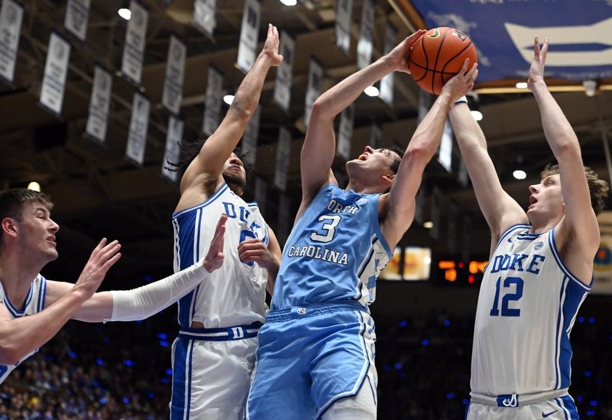 Mar 9, 2024; Durham, North Carolina, USA; North Carolina Tar Heels guard Cormac Ryan (3) shoots over  Duke Blue Devils guard Jared McCain (0) during the first half at Cameron Indoor Stadium.