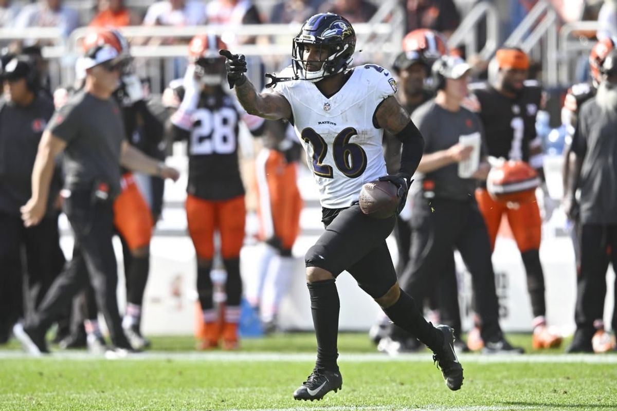 Baltimore Ravens safety Geno Stone (26) celebrates after intercepting a pass in the first quarter against the Cleveland Browns at Cleveland Browns Stadium.