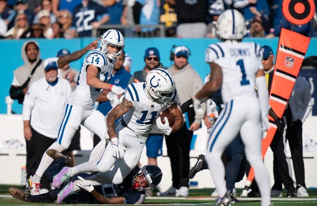 Indianapolis Colts wide receiver Michael Pittman Jr. (11) is tackled after a catch by Tennessee Titans cornerback Sean Murphy-Bunting (0) during their game at Nissan Stadium in Nashville, Tenn., Sunday, Dec. 3, 2023.