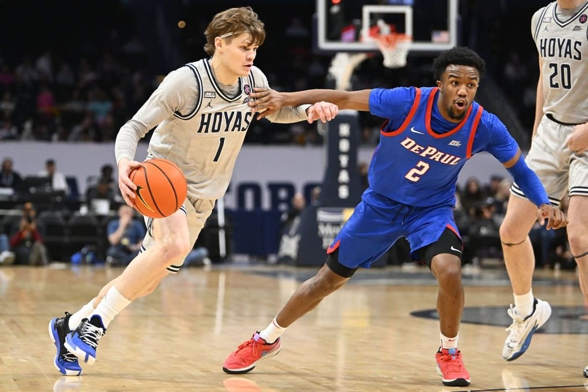 Jan 6, 2024; Washington, District of Columbia, USA; Georgetown Hoyas guard Rowan Brumbaugh (1) dribbles as DePaul Blue Demons guard Chico Carter Jr. (2) defends during the first half at Capital One Arena.