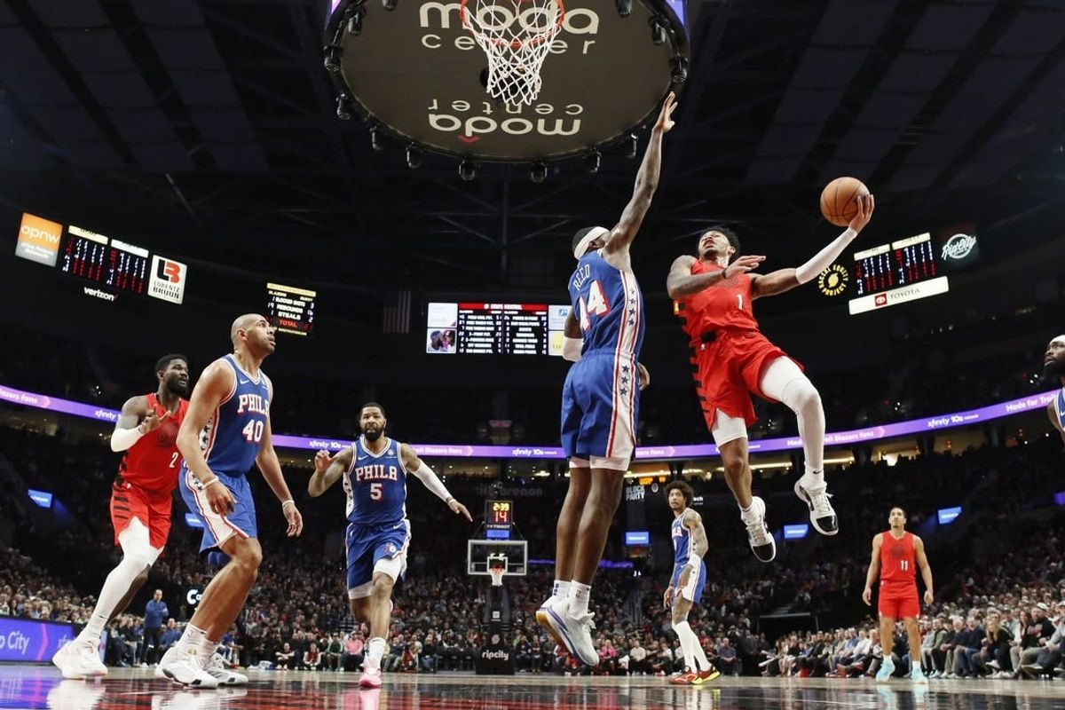 Jan 29, 2024; Portland, Oregon, USA; Portland Trail Blazers shooting guard Anfernee Simons (1) shoots the ball over Philadelphia 76ers small forward Paul Reed (44) during the first half at Moda Center.