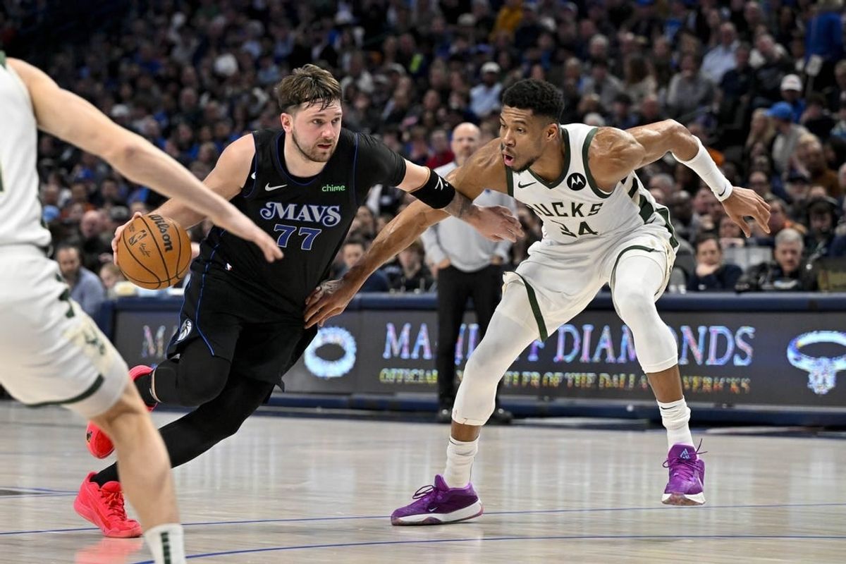 Feb 3, 2024; Dallas, Texas, USA; Dallas Mavericks guard Luka Doncic (77) drives to the basket past Milwaukee Bucks forward Giannis Antetokounmpo (34) during the second quarter at the American Airlines Center.