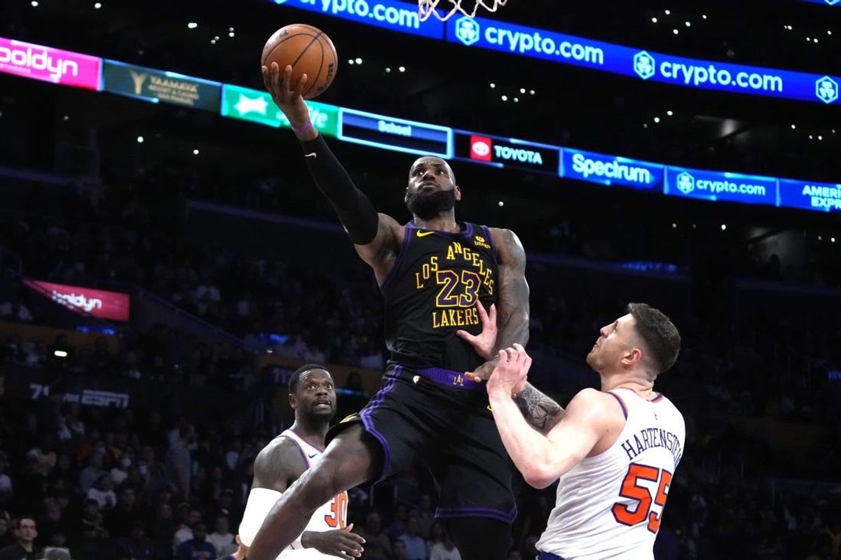 Dec 18, 2023; Los Angeles, California, USA; Los Angeles Lakers forward LeBron James (23) shoots the ball against New York Knicks center Isaiah Hartenstein (55) in the second half at Crypto.com Arena.