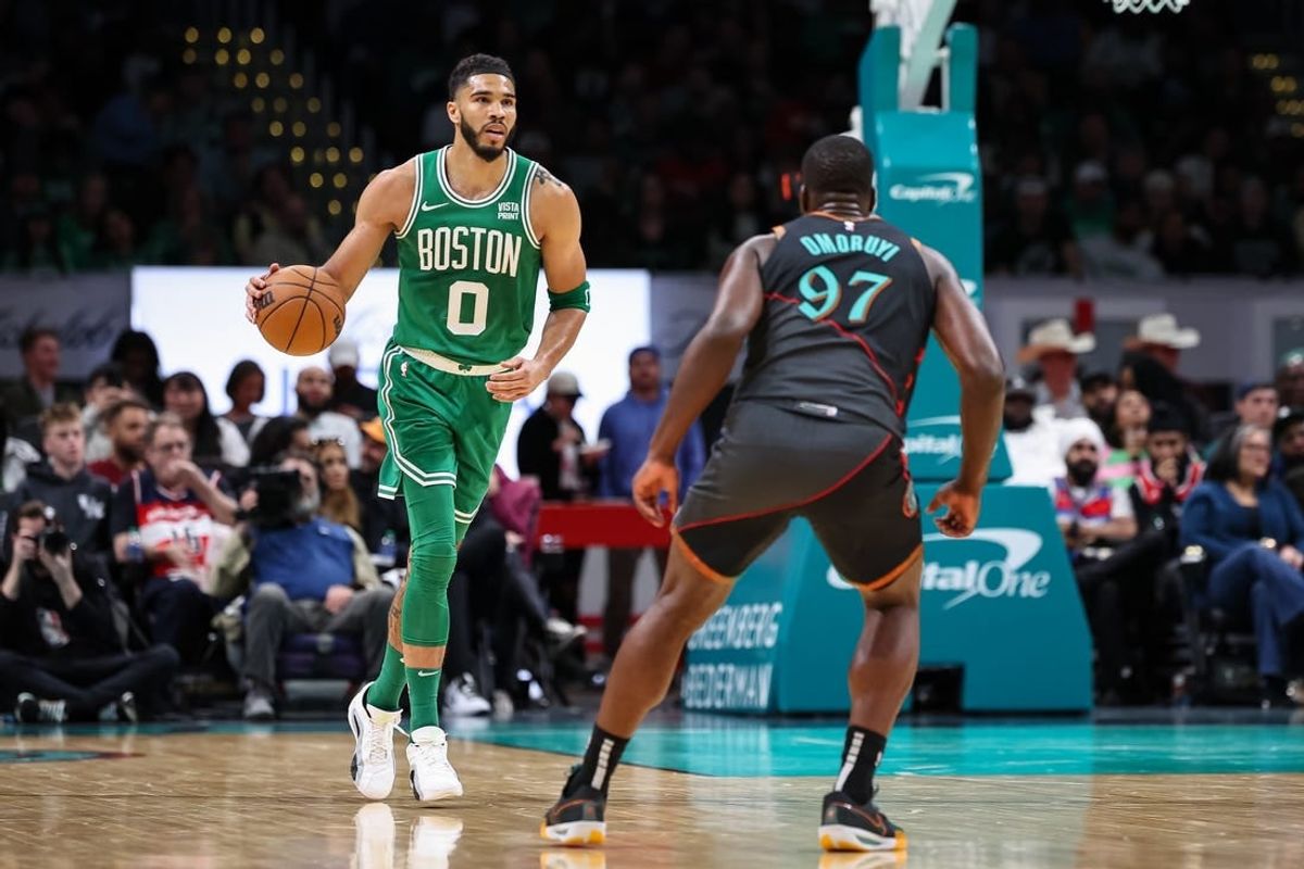 Mar 17, 2024; Washington, District of Columbia, USA; Boston Celtics forward Jayson Tatum (0) brings the ball up court against Washington Wizards forward Eugene Omoruyi (97) during the first half of the game at Capital One Arena.