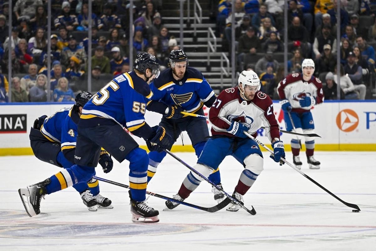 Dec 29, 2023; St. Louis, Missouri, USA;  Colorado Avalanche left wing Jonathan Drouin (27) controls the puck as St. Louis Blues defenseman Colton Parayko (55) defends during the first period at Enterprise Center.