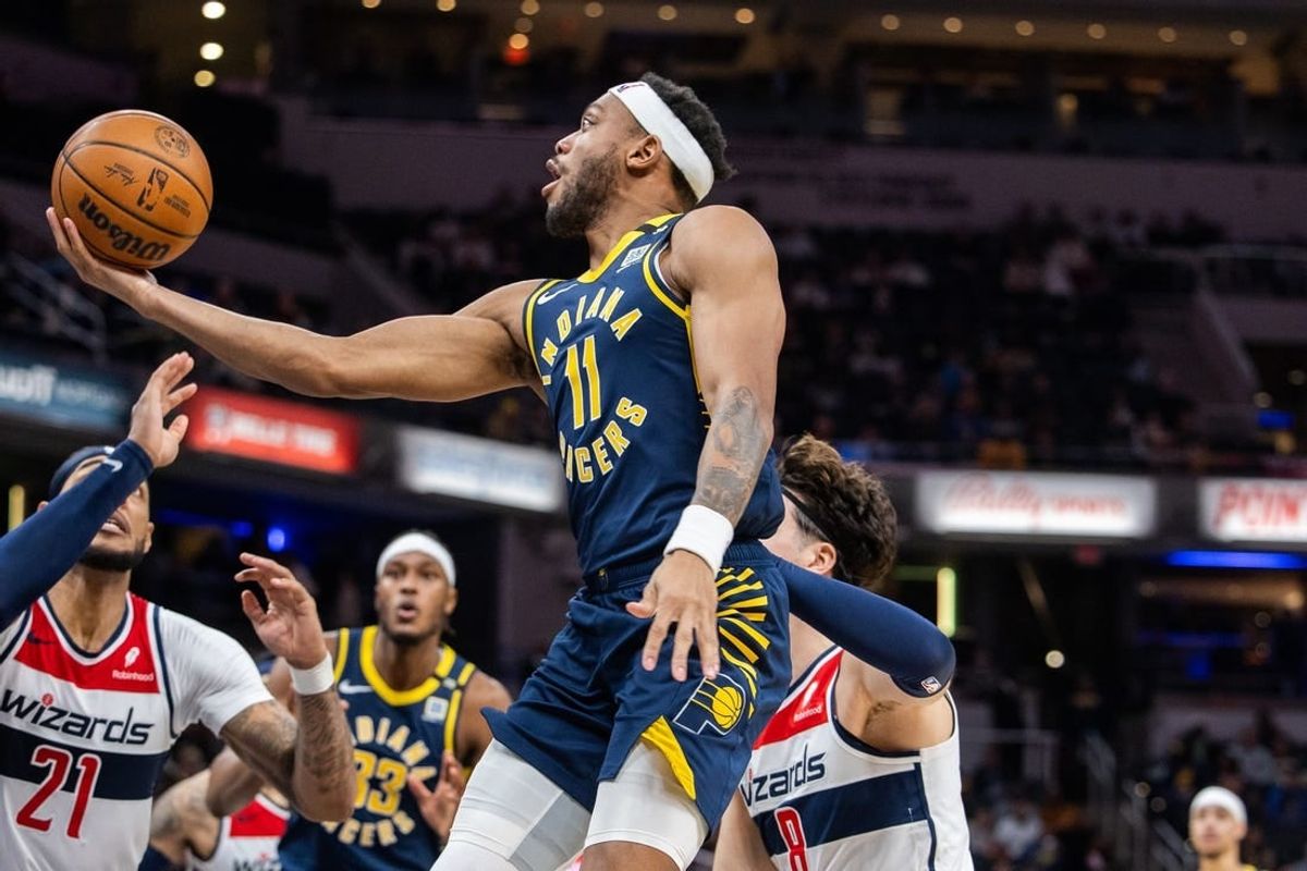 Jan 10, 2024; Indianapolis, Indiana, USA; Indiana Pacers forward Bruce Brown (11) shoots the ball while Washington Wizards forward Deni Avdija (8) defends in the second half at Gainbridge Fieldhouse.