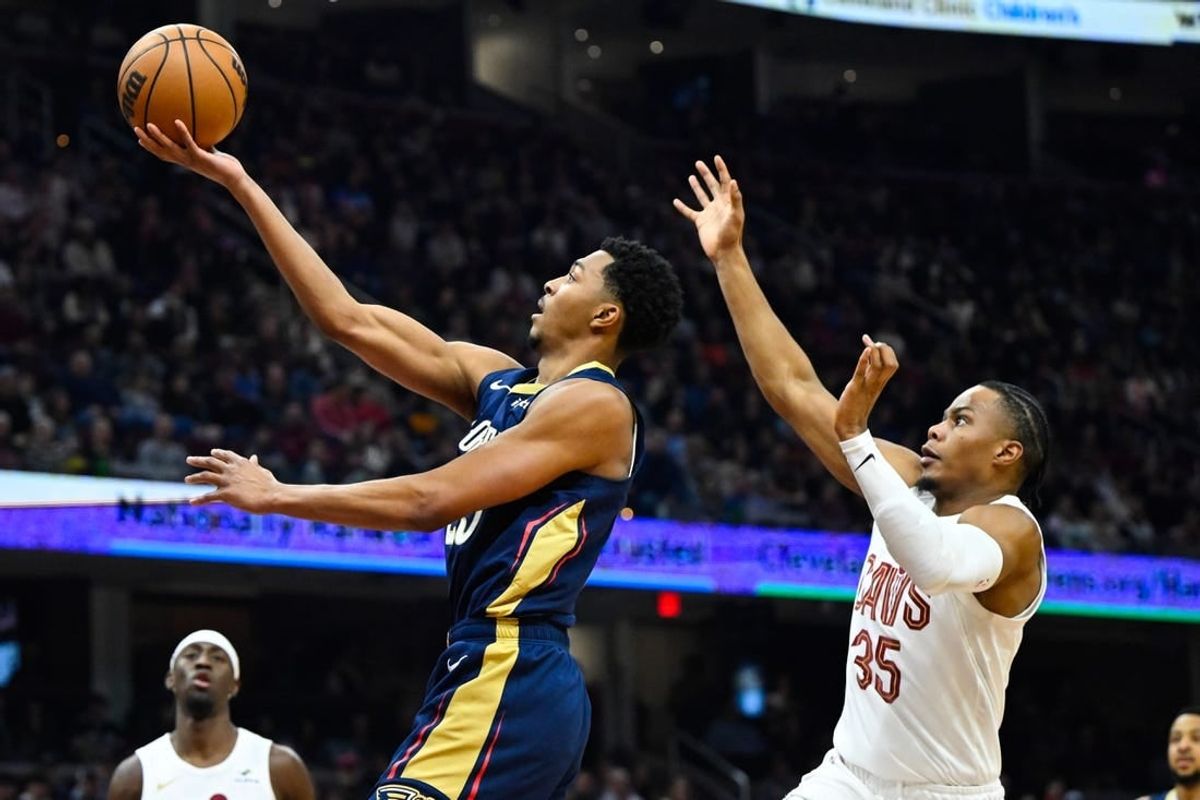 Dec 21, 2023; Cleveland, Ohio, USA; New Orleans Pelicans guard Trey Murphy III (25) drives to the basket beside Cleveland Cavaliers forward Isaac Okoro (35) in the second quarter at Rocket Mortgage FieldHouse.