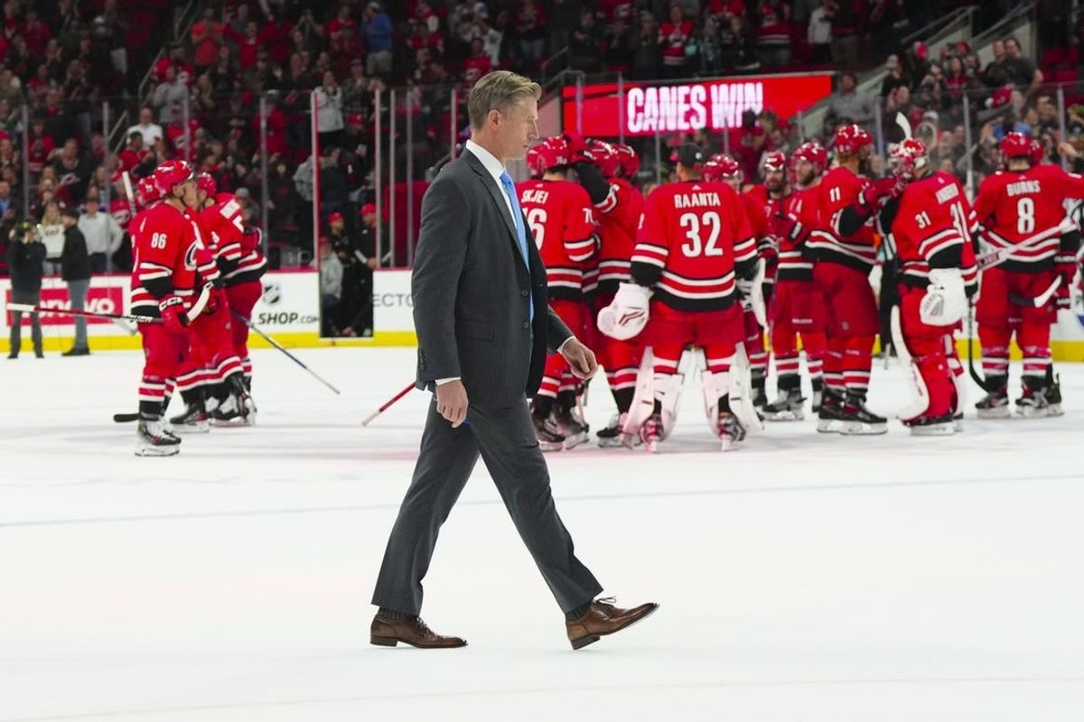 Oct 26, 2023; Raleigh, North Carolina, USA; Seattle Kraken head coach Dave Hakstol walks off the ice as the Carolina Hurricanes celebrate there victory win the over time at PNC Arena.