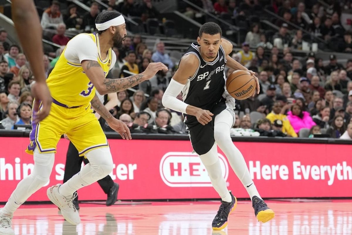 Dec 13, 2023; San Antonio, Texas, USA;  San Antonio Spurs center Victor Wembanyama (1) dribbles against Los Angeles Lakers forward Anthony Davis (3) in the first half at the Frost Bank Center.