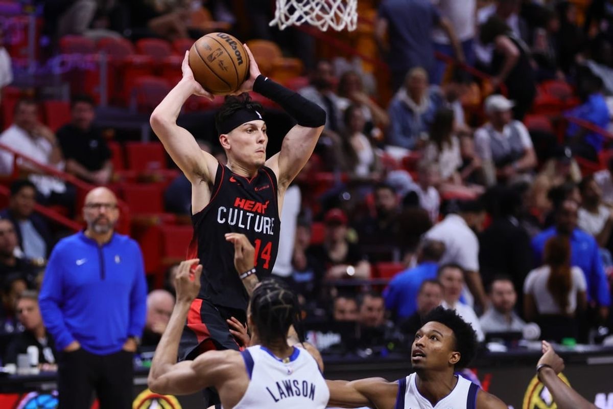 Apr 10, 2024; Miami, Florida, USA; Miami Heat guard Tyler Herro (14) controls the basketball against the Dallas Mavericks during the fourth quarter at Kaseya Center.