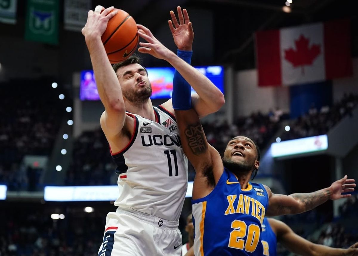 Jan 28, 2024; Hartford, Connecticut, USA; UConn Huskies forward Alex Karaban (11) works for the rebound against Xavier Musketeers guard Dayvion McKnight (20) in the first half at XL Center.