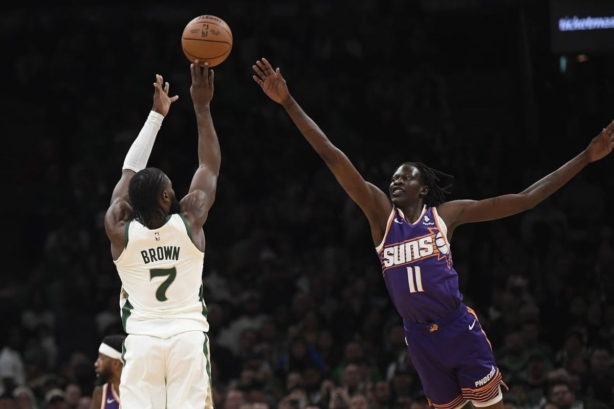 Mar 14, 2024; Boston, Massachusetts, USA;  Boston Celtics guard Jaylen Brown (7) shoots the ball over Phoenix Suns center Bol Bol (11) during the first half at TD Garden.