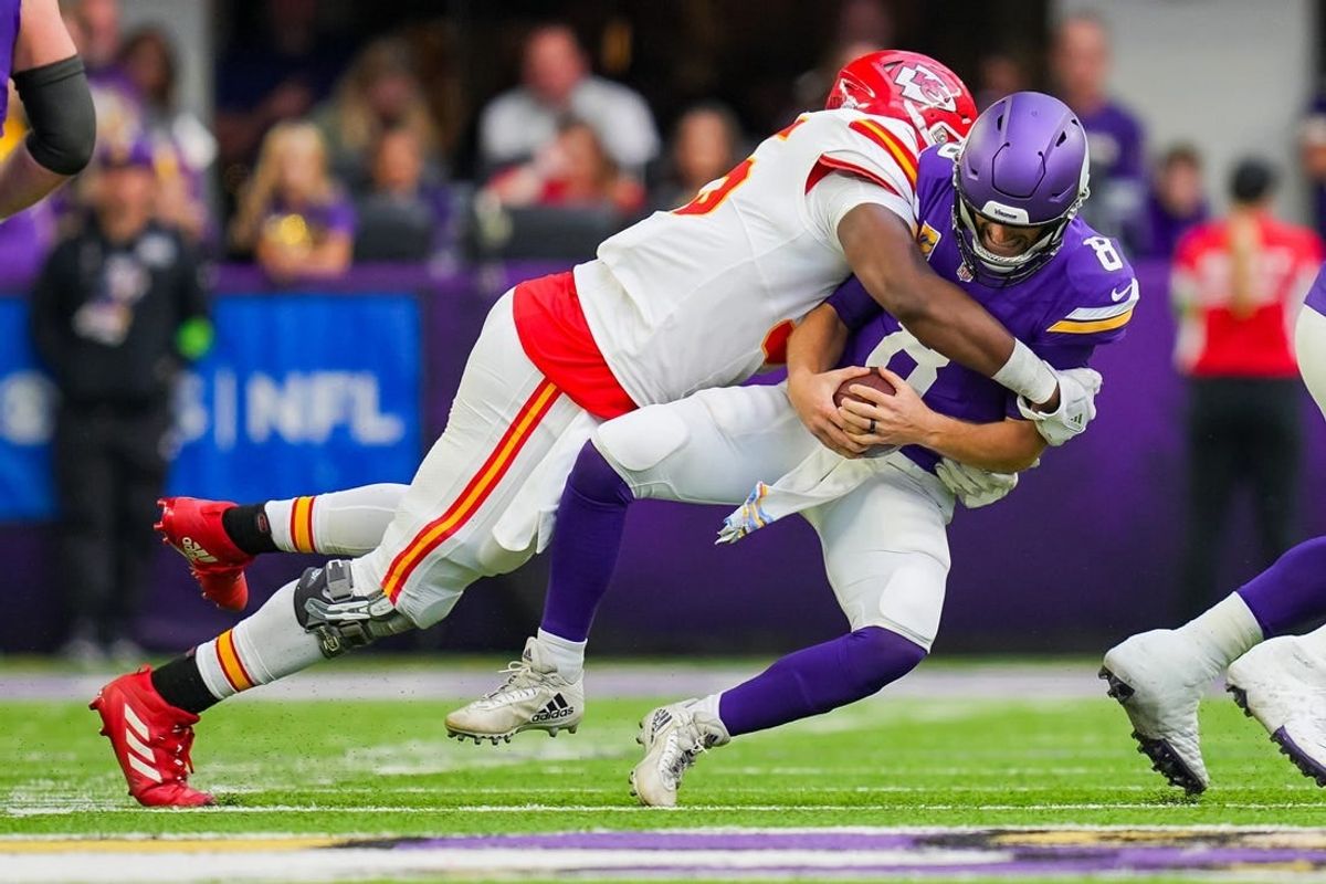 Oct 8, 2023; Minneapolis, Minnesota, USA; Kansas City Chiefs defensive tackle Chris Jones (95) sacks Minnesota Vikings quarterback Kirk Cousins (8) in the second quarter at U.S. Bank Stadium.