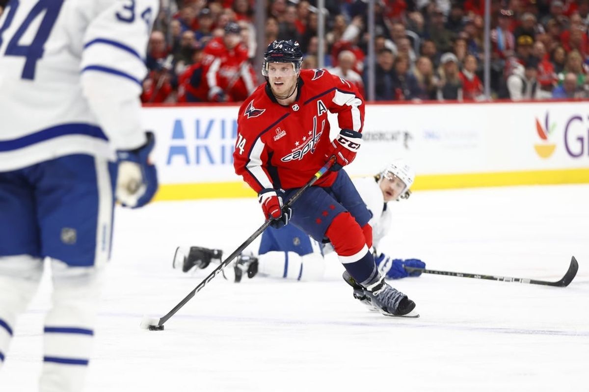 Mar 20, 2024; Washington, District of Columbia, USA; Washington Capitals defenseman John Carlson (74) skates with the puck as Toronto Maple Leafs left wing Tyler Bertuzzi (59) during the third period at Capital One Arena.