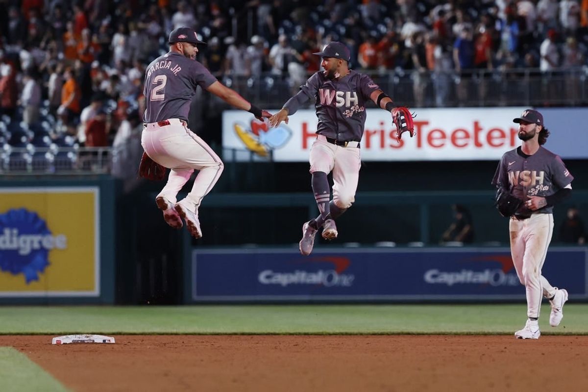 May 7, 2024; Washington, District of Columbia, USA; Washington Nationals second baseman Luis Garcia Jr. (2) celebrates with Nationals outfielder Eddie Rosario (8) after their game against the Baltimore Orioles at Nationals Park.