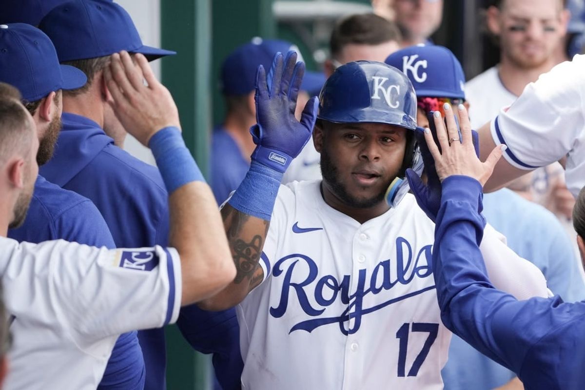 Mar 31, 2024; Kansas City, Missouri, USA; Kansas City Royals right fielder Nelson Velazquez (17) is congratulated in the dugout against the Minnesota Twins after hitting a solo home run in the sixth inning at Kauffman Stadium.