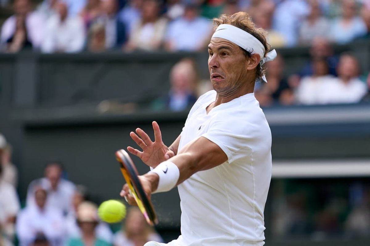 Jul 6, 2022; London, England, United Kingdom; Rafael Nadal (ESP) returns a shot during his quarter finals men s singles match against Taylor Fritz (USA) on Centre court at All England Lawn Tennis and Croquet Club.