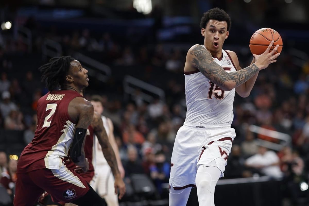 Mar 13, 2024; Washington, D.C., USA; Virginia Tech Hokies center Lynn Kidd (15) drives to the basket as Florida State Seminoles forward Jamir Watkins (2) defends in the first half at Capital One Arena.