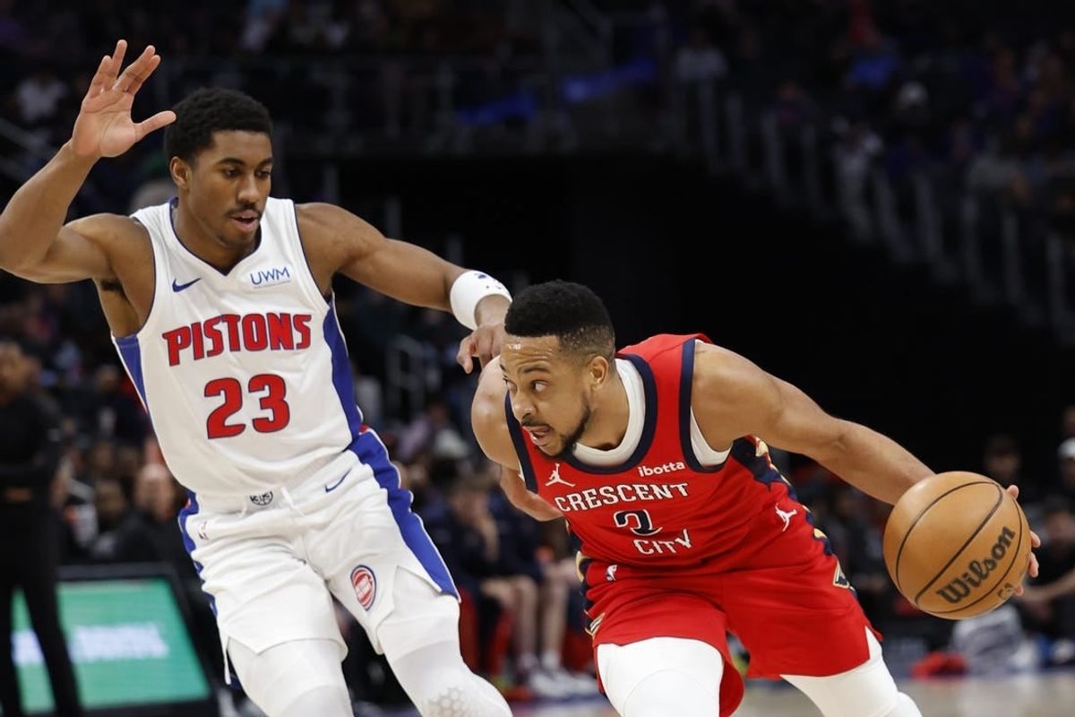 Mar 24, 2024; Detroit, Michigan, USA;  New Orleans Pelicans guard CJ McCollum (3) dribbles on Detroit Pistons guard Jaden Ivey (23) in the first half at Little Caesars Arena.