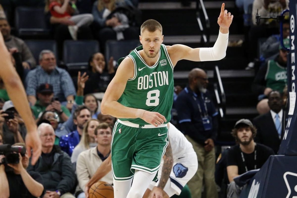 Nov 19, 2023; Memphis, Tennessee, USA; Boston Celtics center Kristaps Porzingis (8) reacts after a dunk during the second half against the Memphis Grizzlies at FedExForum.