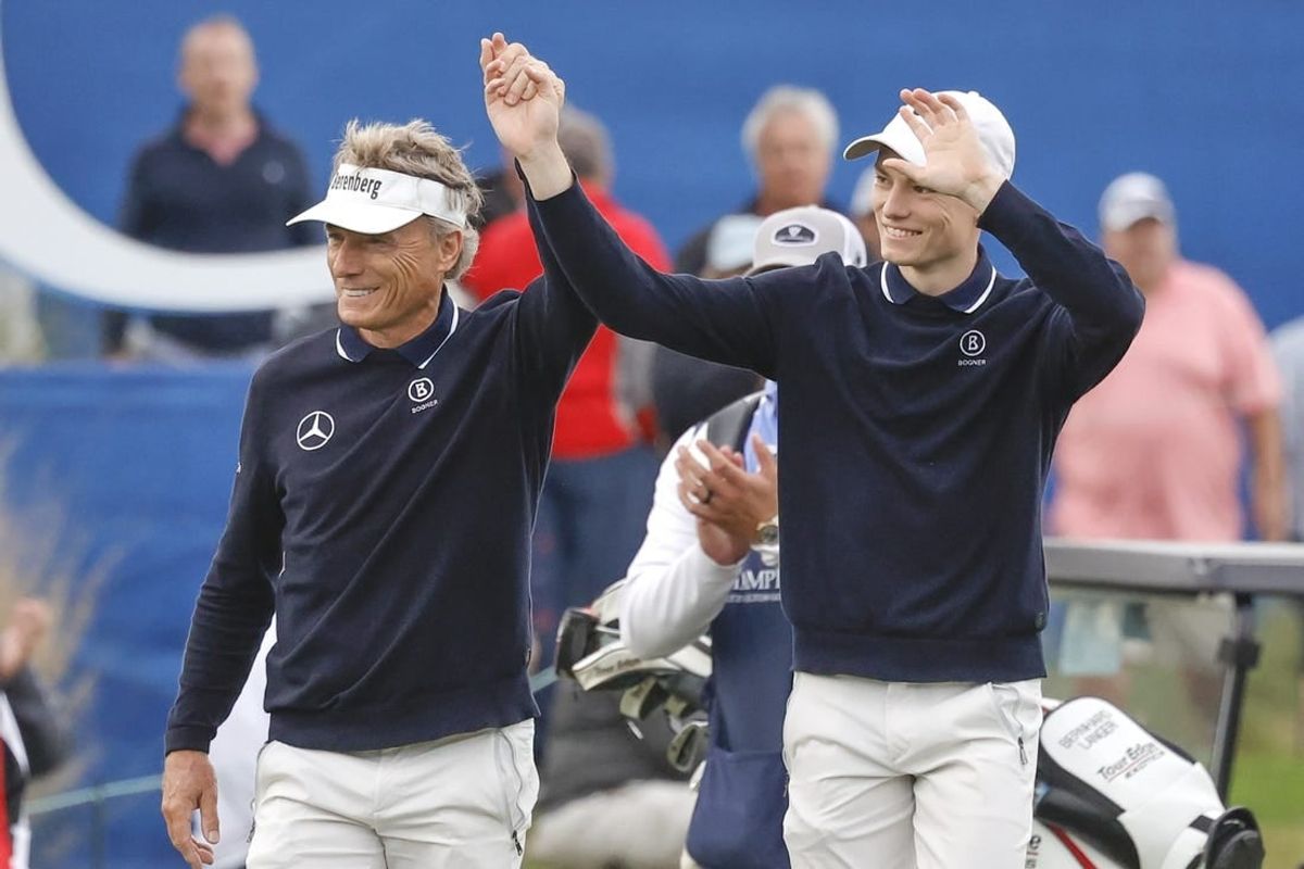 Dec 17, 2023; Orlando, Florida, USA;  Bernhard Langer (left) and his son Jason Langer react to the crowd after they are announced walking onto the 18th green at the PNC Championship at The Ritz-Carlton Golf Club.