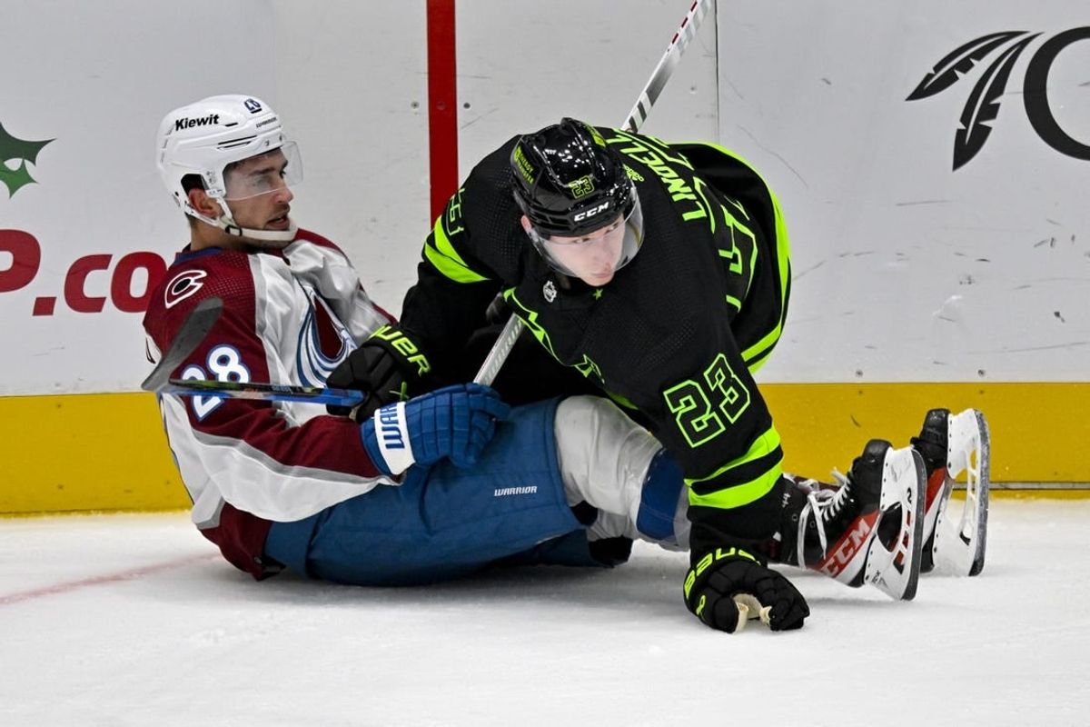 Nov 18, 2023; Dallas, Texas, USA; Dallas Stars defenseman Esa Lindell (23) checks Colorado Avalanche left wing Miles Wood (28) during the second period at the American Airlines Center.