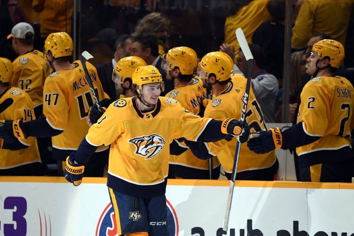 Mar 2, 2024; Nashville, Tennessee, USA; Nashville Predators center Cody Glass (8) celebrates with his teammates after a goal during the second period against the Colorado Avalanche at Bridgestone Arena.