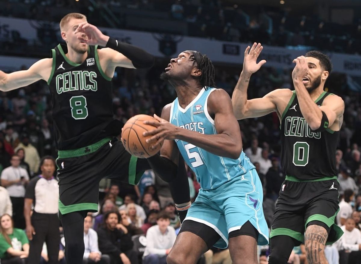 Nov 20, 2023; Charlotte, North Carolina, USA; Charlotte Hornets Center Mark Williams (5) looks to shoot as he is defended by Boston Celtics forward center Kristaps Porzingis (8) and forward Jayson Tatum (0) during the second half at the Spectrum Center.