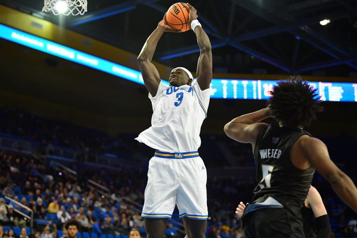 January 14, 2024; Los Angeles, California, USA; UCLA Bruins forward Adem Bona (3) moves to the basket against Washington Huskies guard Sahvir Wheeler (5) during the second half at Pauley Pavilion.