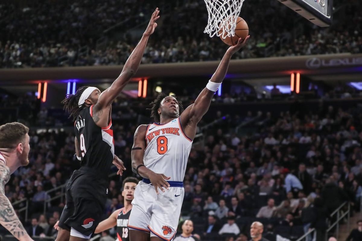 Jan 9, 2024; New York, New York, USA; New York Knicks forward OG Anunoby (8) drives past Portland Trail Blazers forward Jerami Grant (9) for a layup in the third quarter at Madison Square Garden.