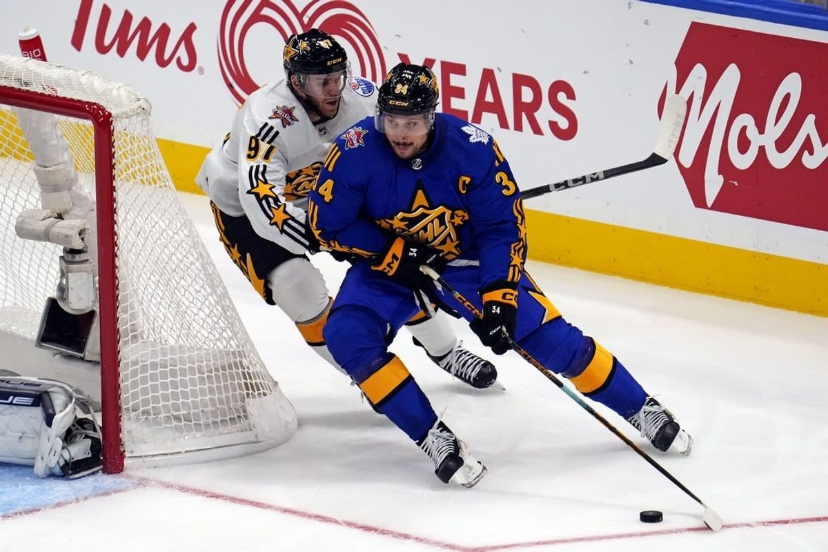 Feb 3, 2024; Toronto, Ontario, CAN; Team Matthews center Auston Matthews (34) of the Toronto Maple Leafs moves the puck against Team McDavid center Connor McDavid (97) of the Edmonton Oilers in the 2024 NHL All-Star Game at Scotiabank Arena.