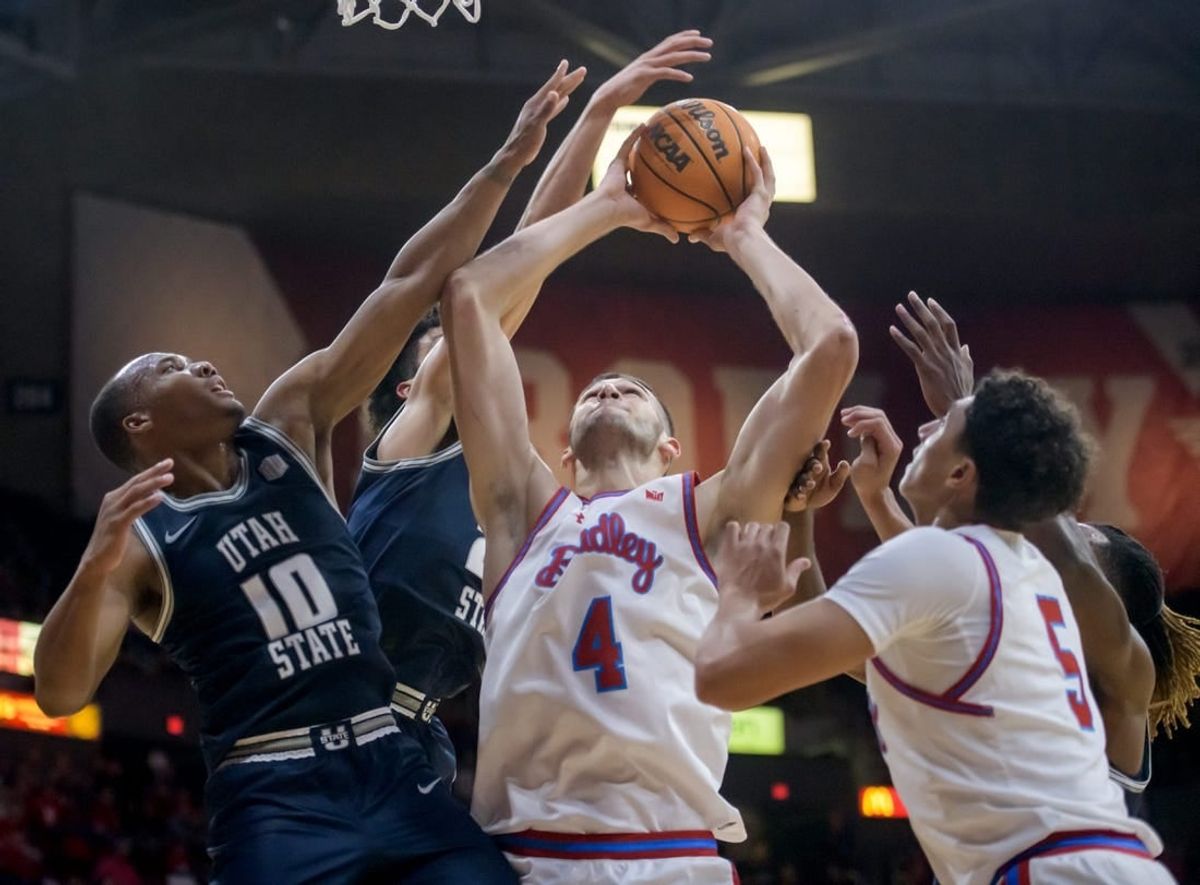 Bradley's Ahmet Jonovic (4) battles for a rebound with Utah State's Darius Brown II (10) in the second half of the Braves' home opener Saturday, Nov. 11, 2023 at Carver Arena.