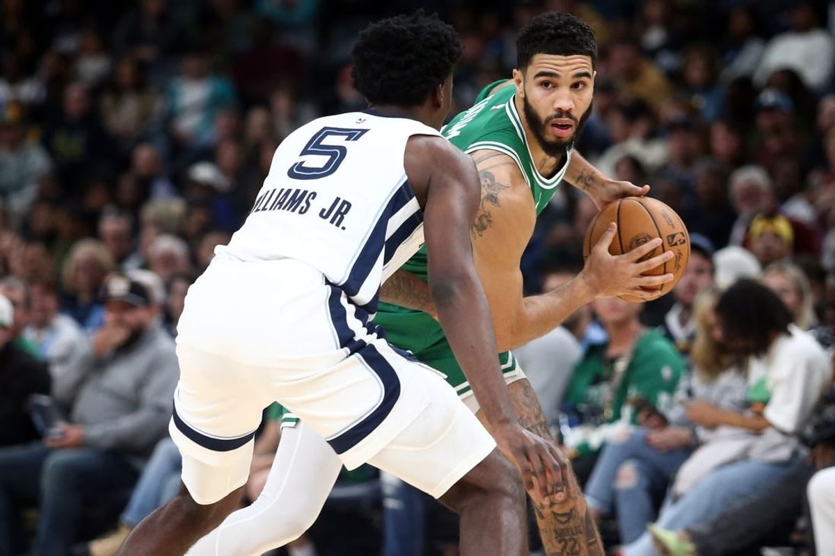 Nov 19, 2023; Memphis, Tennessee, USA; Boston Celtics forward Jayson Tatum (0) handles the ball as Memphis Grizzlies guard Vince Williams Jr. (5) defends during the first half at FedExForum.
