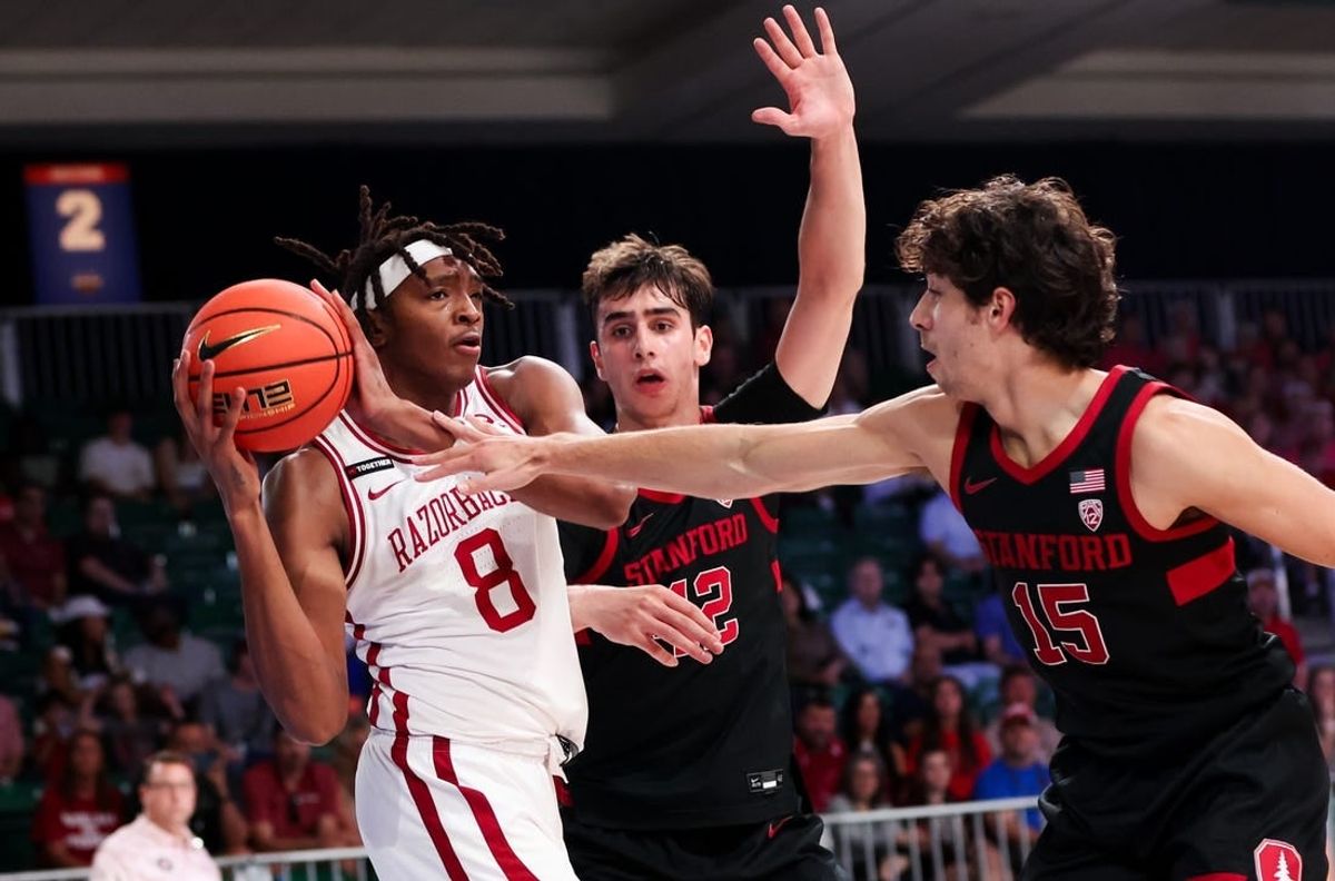 Nov 22, 2023; Paradise Island, BAHAMAS;  Arkansas Razorbacks forward Chandler Lawson (8) looks to pass as Stanford Cardinal guard Benny Gealer (15) defends during the first half at Imperial Arena.