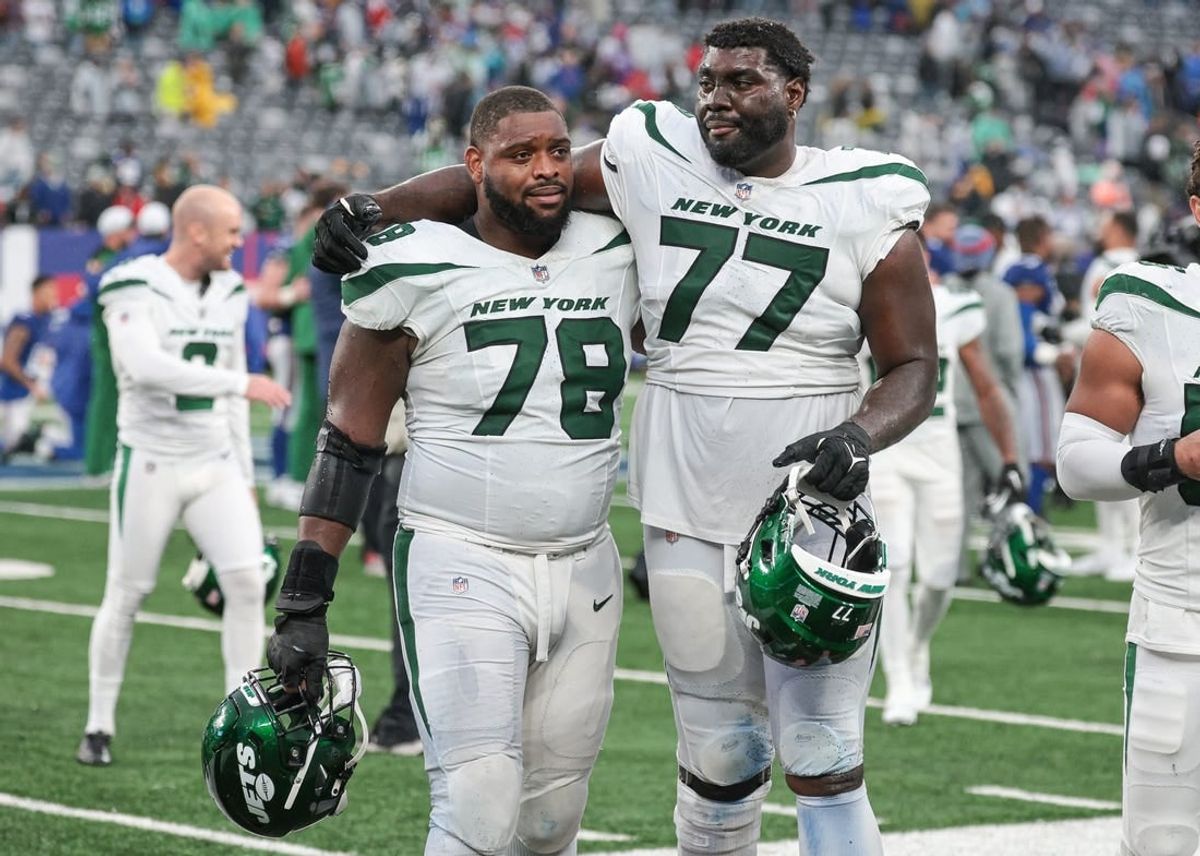 Oct 29, 2023; East Rutherford, New Jersey, USA; New York Jets guard Laken Tomlinson (78) and offensive tackle Mekhi Becton (77) walk off the field after defeating the New York Giants in overtime at MetLife Stadium.