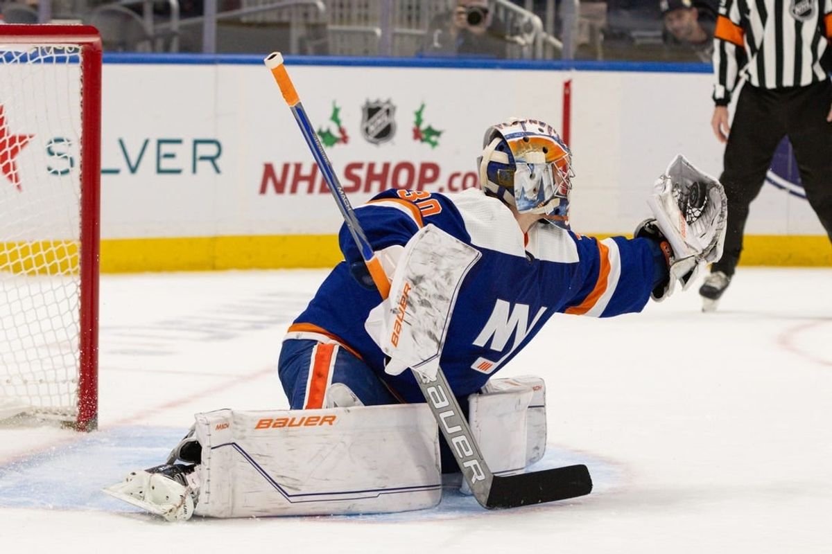 Nov 25, 2023; Elmont, New York, USA; New York Islanders goaltender Ilya Sorokin (30) makes a glove save against the Philadelphia Flyers during the overtime shootout at UBS Arena.
