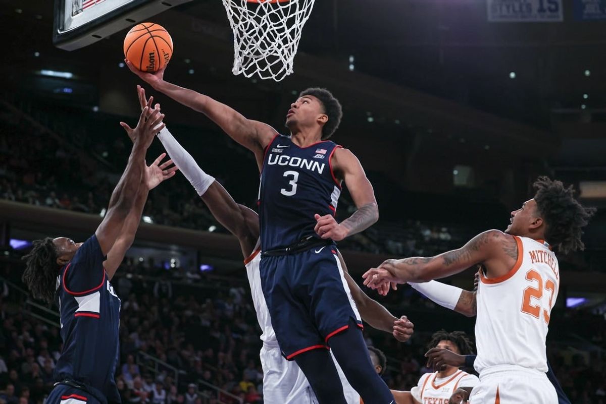 Nov 20, 2023; New York, NY, USA; Connecticut Huskies forward Jaylin Stewart (3) and guard Tristen Newton (2) rebound against Texas Longhorns forward Ze'Rik Onyema (21) and forward Dillon Mitchell (23) during the first half of the Empire Classic championship game at Madison Square Garden.