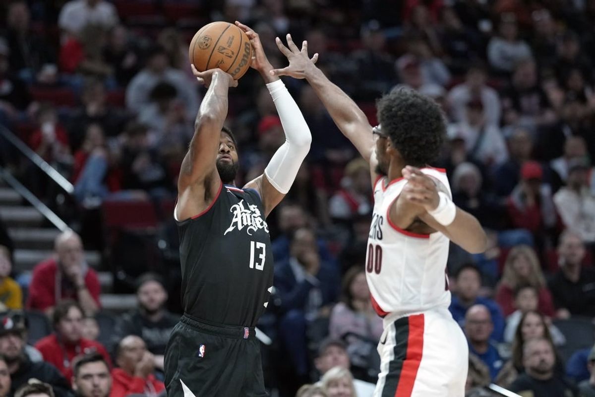 Mar 22, 2024; Portland, Oregon, USA; LA Clippers forward Paul George (13) shoots the ball over Portland Trail Blazers guard Scoot Henderson (00) during the second half at Moda Center.