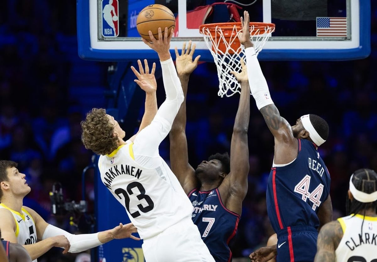 Jan 6, 2024; Philadelphia, Pennsylvania, USA; Utah Jazz forward Lauri Markkanen (23) scores past Philadelphia 76ers center Mo Bamba (7) and forward Paul Reed (44) during the first quarter at Wells Fargo Center.