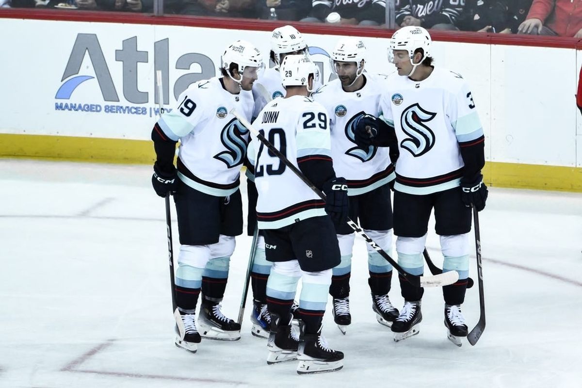 Feb 12, 2024; Newark, New Jersey, USA; Seattle Kraken defenseman Will Borgen (3) celebrates with teammates after scoring a goal against the New Jersey Devils during the third period at Prudential Center.