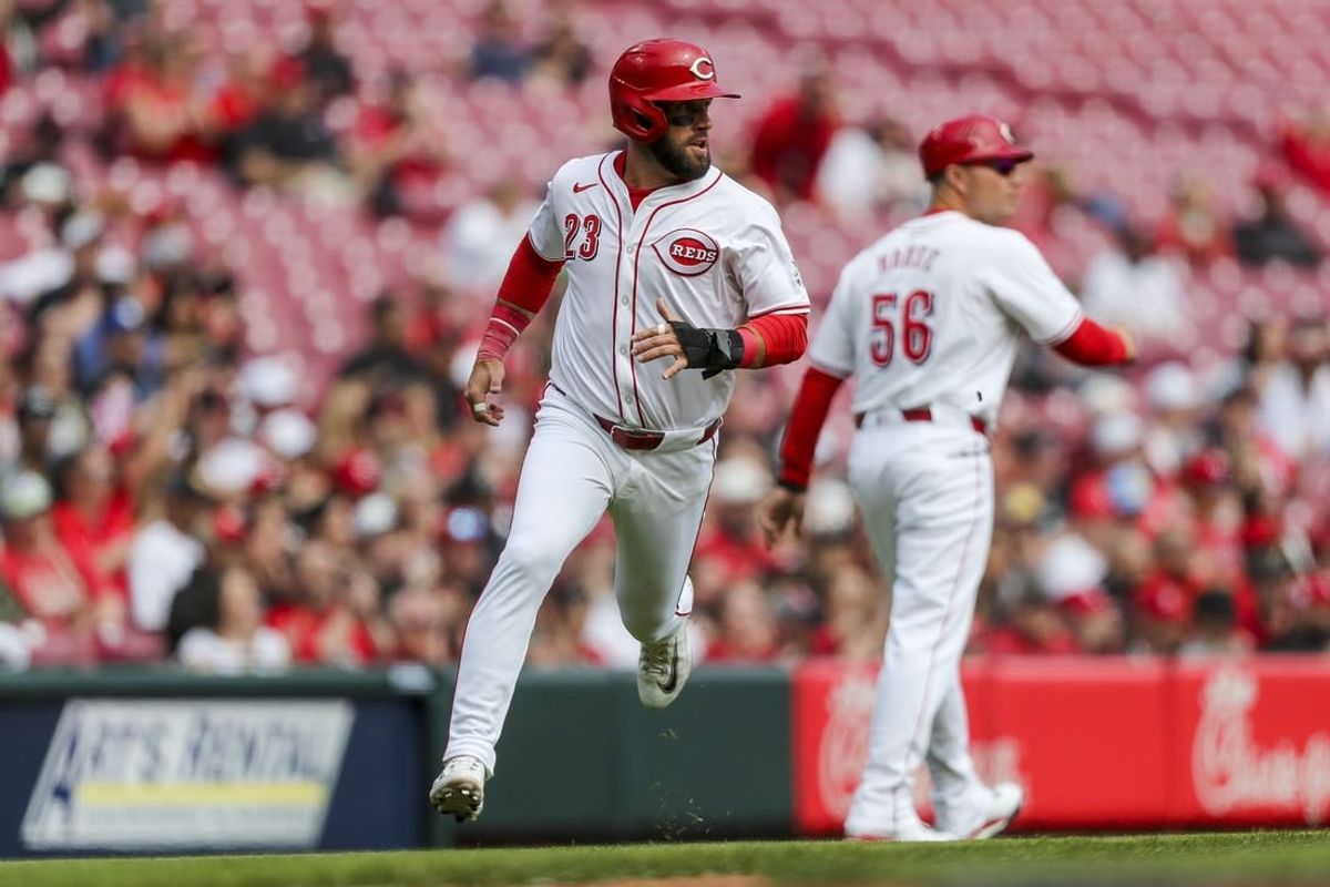 Mar 31, 2024; Cincinnati, Ohio, USA; Cincinnati Reds designated hitter Nick Martini (23) scores on a double hit by center fielder Will Benson (30) in the third inning against the Washington Nationals at Great American Ball Park.