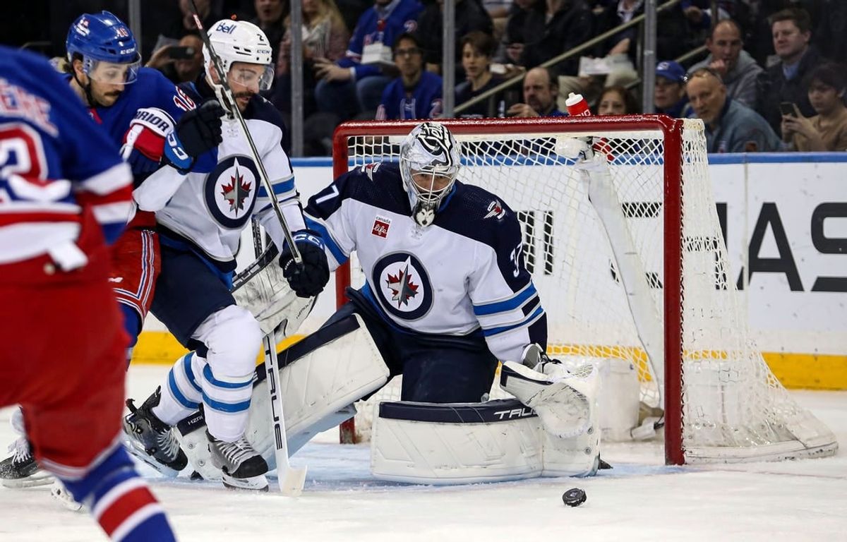 Mar 19, 2024; New York, New York, USA; Winnipeg Jets goalie Connor Hellebuyck (37) makes a save against the New York Rangers during the first period at Madison Square Garden.