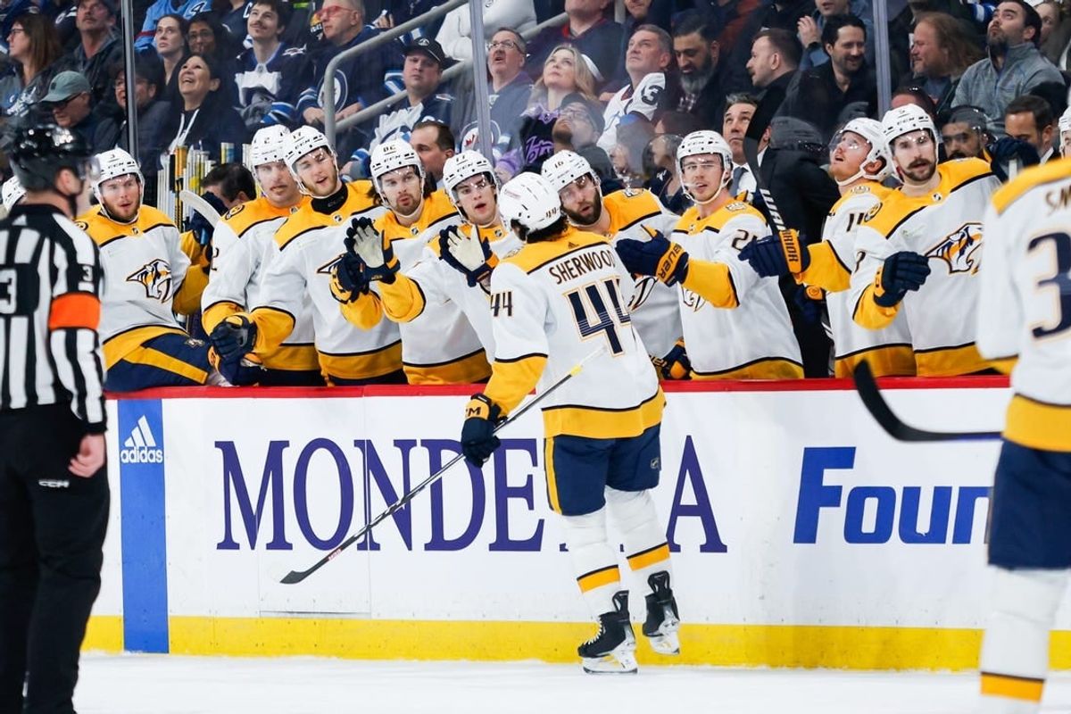 Mar 13, 2024; Winnipeg, Manitoba, CAN; Nashville Predators forward Keifer Sherwood (44) is congratulated by his team mates on his goal against the Winnipeg Jets during the first period at Canada Life Centre.
