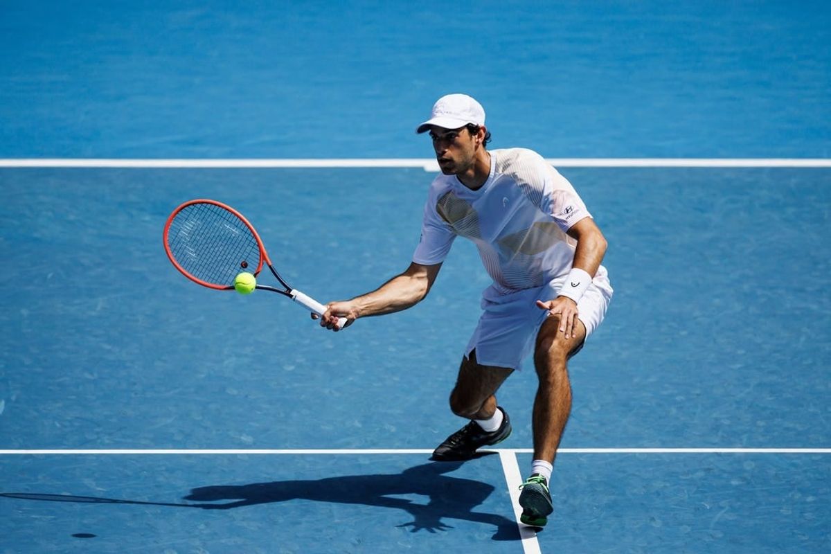 Jan 22, 2024; Melbourne, Victoria, Australia; Nuno Borges of Portugal hits a shot against Daniil Medvedev of Russia in the fourth round of the men   s singles at the Australian Open in Melbourne