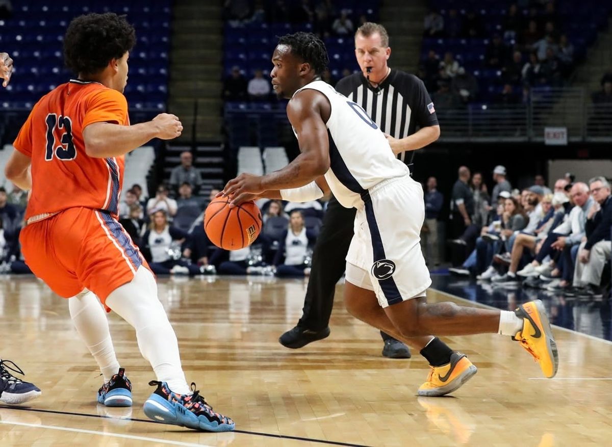 Dec 2, 2023; University Park, Pennsylvania, USA; Penn State Nittany Lions guard Kanye Clary (0) dribbles the ball against Bucknell Bison guard Josh Bascoe (13) during the first half at Bryce Jordan Center.