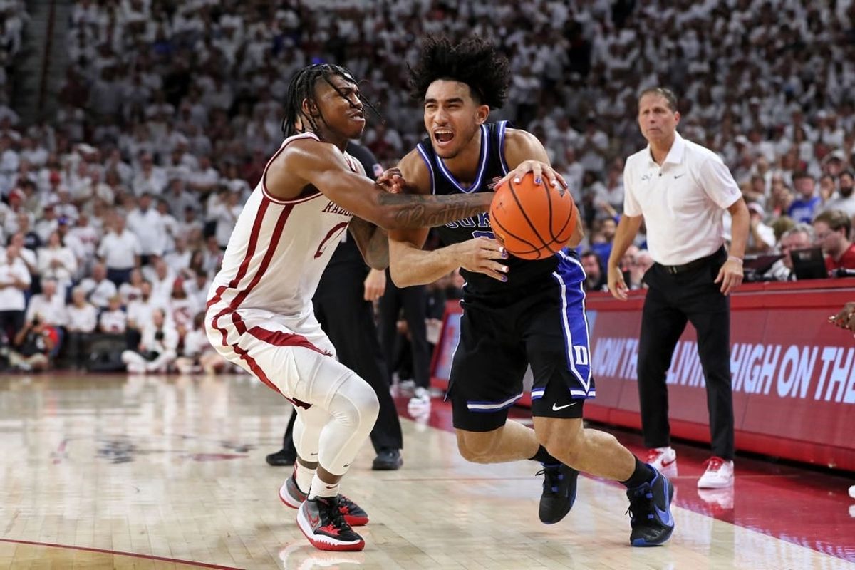 Nov 29, 2023; Fayetteville, Arkansas, USA; Duke Blue Devils guard Jared McCain (0) is fouled by Arkansas Razorbacks Khalif Battle (0) during the first half at Bud Walton Arena.